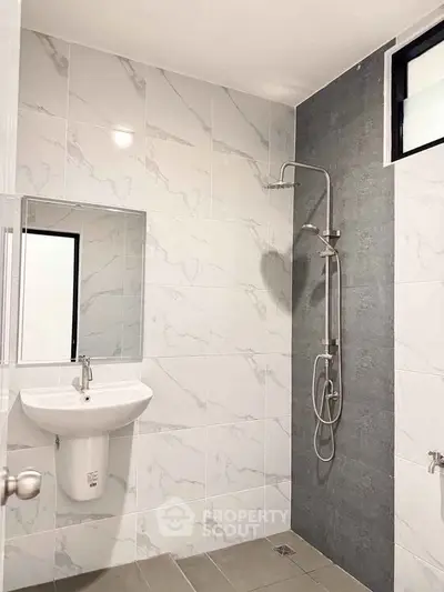 Modern bathroom with sleek shower and elegant tile design