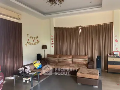 Spacious living room with modern decor and large sectional sofa, perfect for family gatherings.