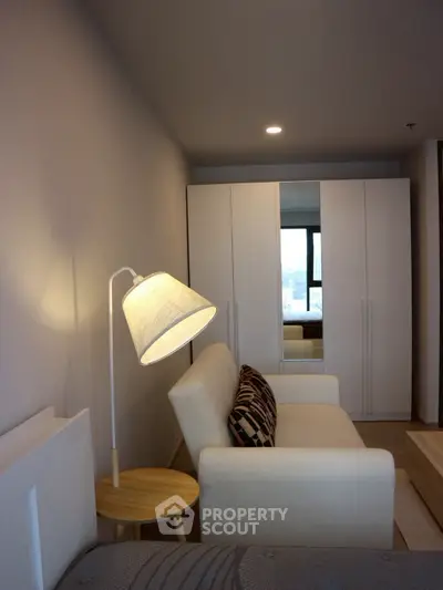 Modern living room with cozy sofa and stylish lamp in a contemporary apartment.