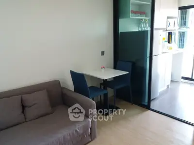 Modern compact living space with kitchenette and cozy seating area