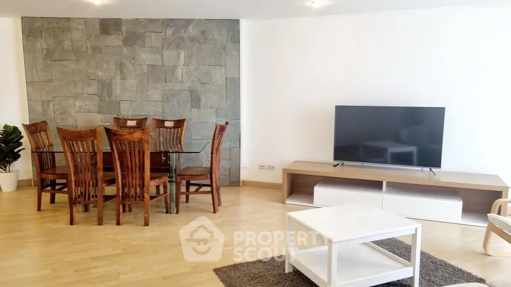 Spacious modern living room with wooden dining set and flat-screen TV