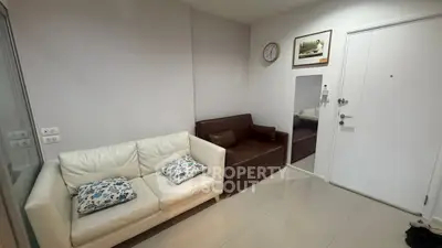 Cozy living room with modern sofas and wall decor in a stylish apartment.