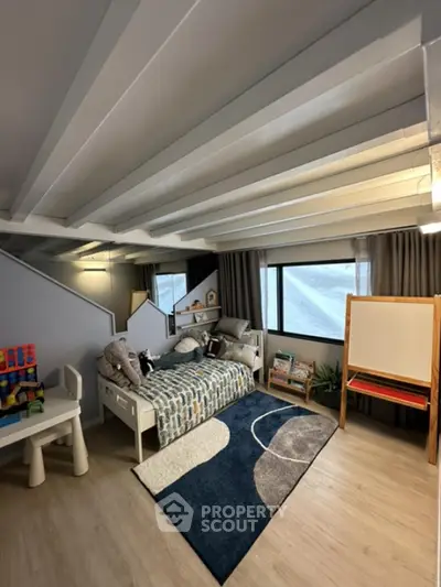 Charming children's bedroom with cozy bed and play area, perfect for family living.