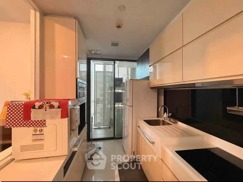 Modern kitchen with sleek cabinetry and appliances in a contemporary apartment
