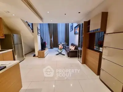 Spacious modern living room with high ceilings and elegant decor in a luxury apartment.