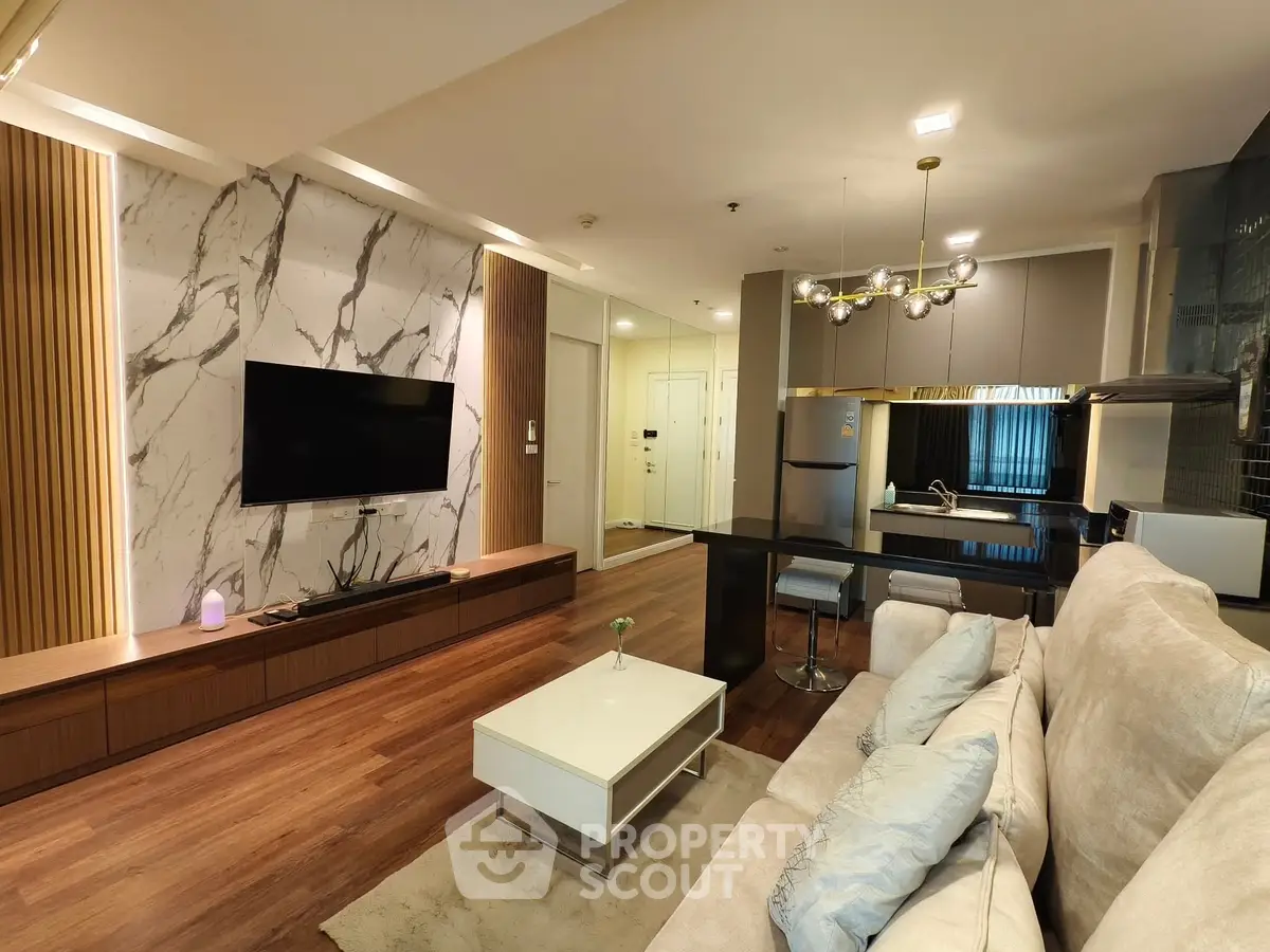 Luxurious modern living room with open kitchen, elegant decor, and stylish lighting.
