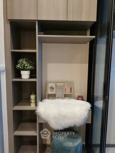 Stylish study nook with shelving and cozy seating in modern apartment