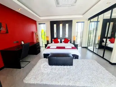 Luxurious modern bedroom with red accents and mirrored wardrobe