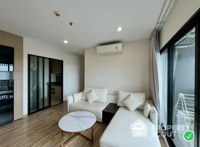 Modern living room with sleek design and natural light, featuring a cozy white sofa and stylish coffee table.