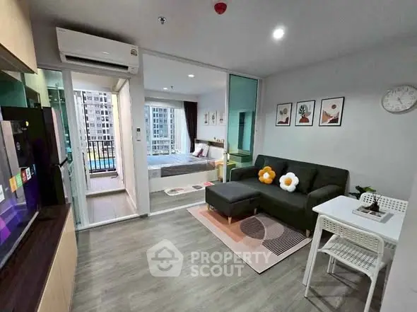 Modern living room with stylish decor and view into cozy bedroom