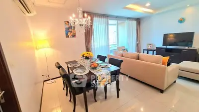 Elegant living room with dining area, chandelier, and modern decor
