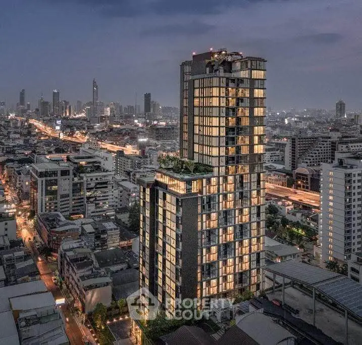 Stunning cityscape view featuring a modern high-rise building with illuminated windows at dusk.