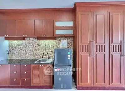 Modern kitchen with wooden cabinets and sleek appliances