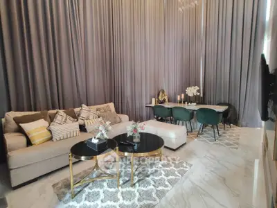 Luxurious living room with high ceilings, elegant furniture, and modern decor.