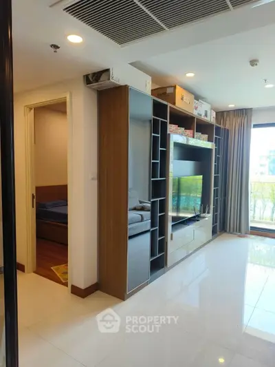 Modern living room with built-in shelving and large window view