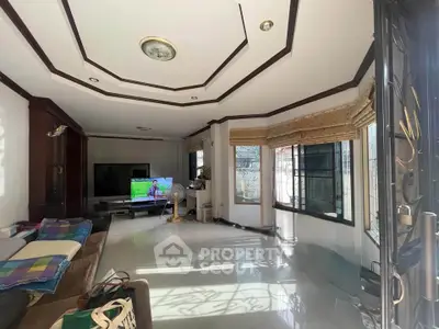 Spacious living room with modern decor and large windows for natural light.