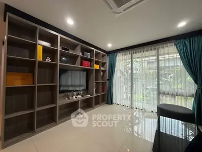 Modern living room with built-in shelving and large window view