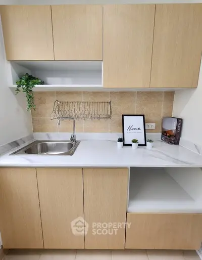 Modern kitchen with sleek cabinetry and stylish decor, perfect for contemporary living.