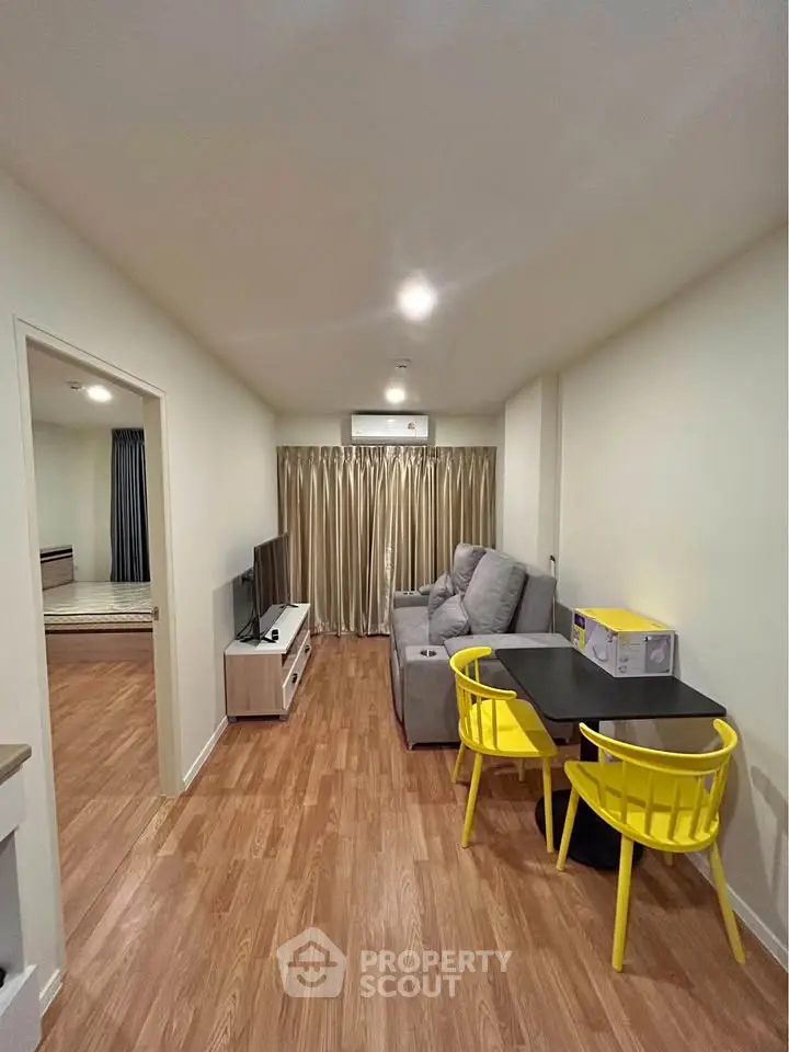 Modern living room with cozy gray sofa and vibrant yellow chairs