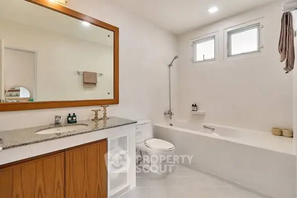 Spacious modern bathroom with bathtub and elegant fixtures