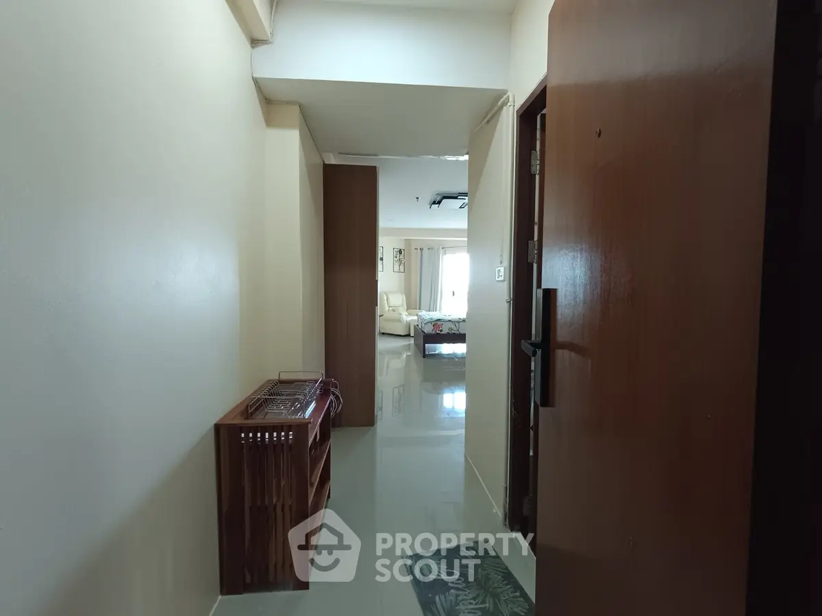 Spacious apartment entrance leading to a bright living area with modern decor.