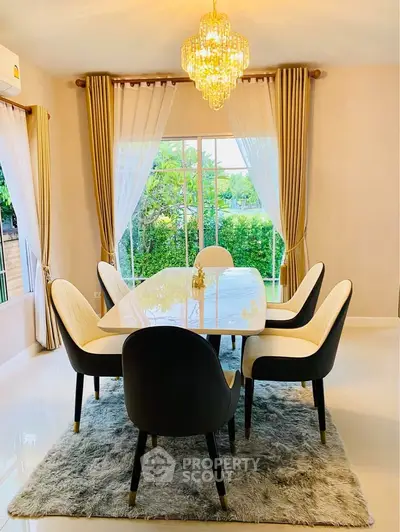 Elegant dining room with chandelier and garden view, perfect for stylish entertaining.