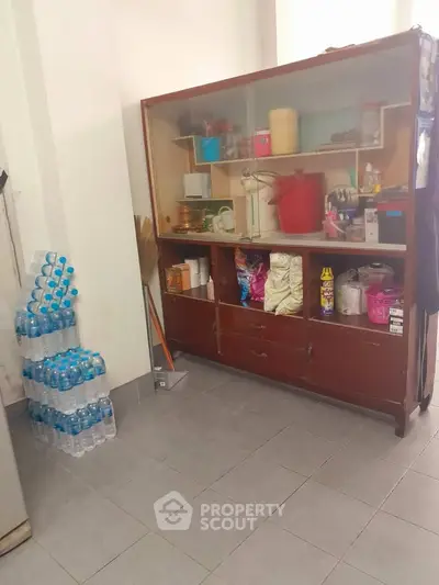 Spacious storage area with vintage cabinet and organized supplies, ideal for efficient home organization.