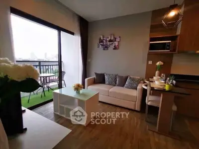 Modern living room with balcony view and stylish kitchen area