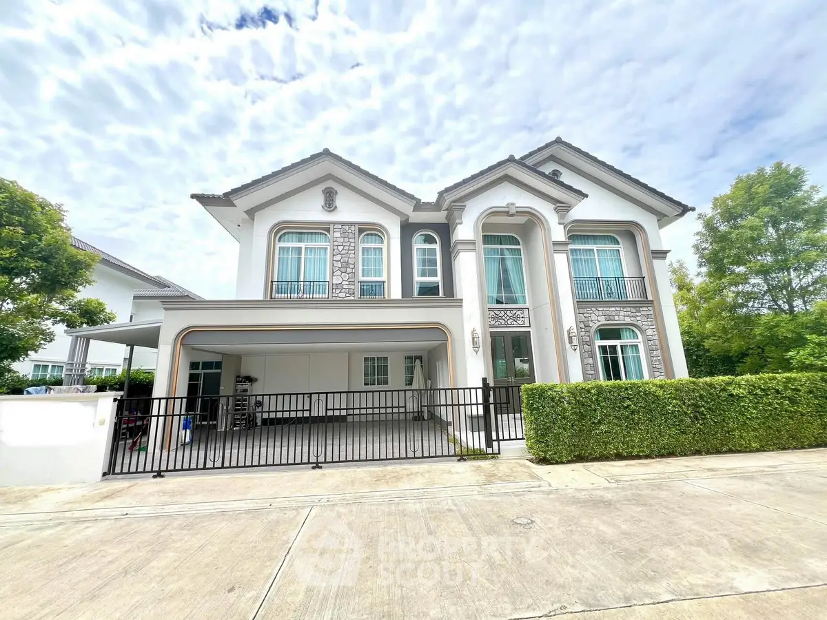 Elegant two-story house with modern architecture and lush greenery, perfect for family living.