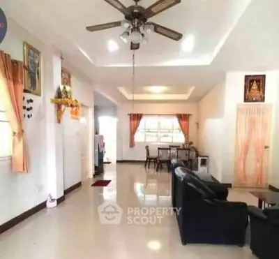 Spacious living room with ceiling fan and elegant decor