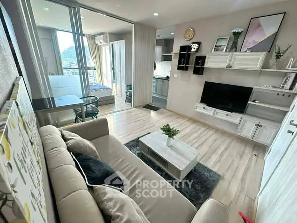 Modern living room with open layout, stylish decor, and natural light in a contemporary apartment.