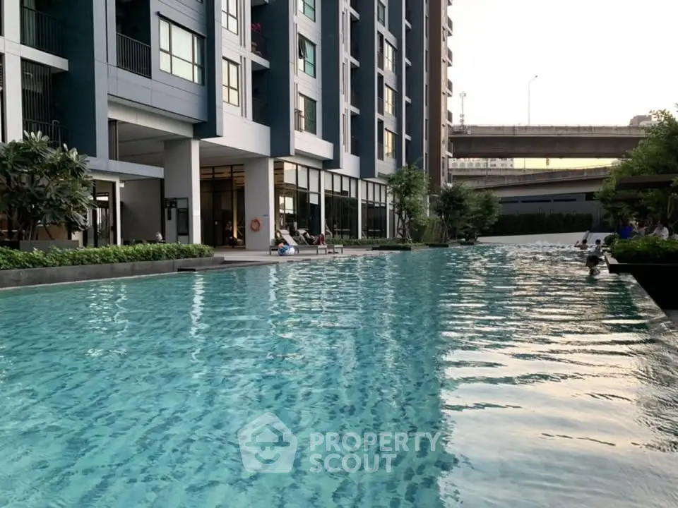 Luxurious condominium with stunning poolside view and modern architecture near urban amenities.