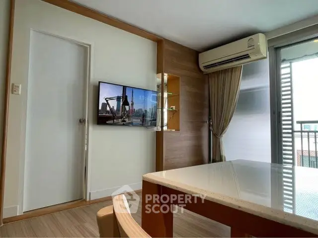Modern living room with balcony access and air conditioning in stylish apartment.