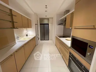 Modern kitchen with sleek cabinetry and built-in appliances in a stylish apartment.