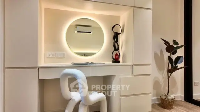 Modern study area with unique chair and stylish decor in a contemporary apartment.