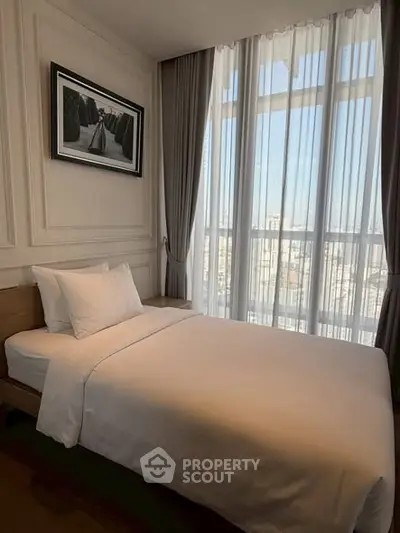 Elegant bedroom with large window and stylish decor