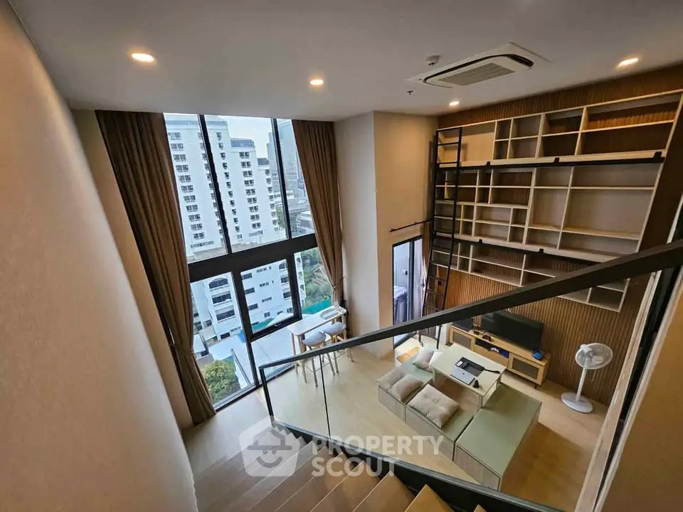Modern loft apartment with high ceilings and large windows offering city views, featuring a stylish living area and open layout.