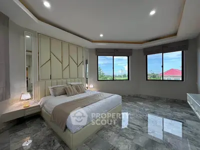 Luxurious bedroom with marble flooring and large windows offering scenic views.