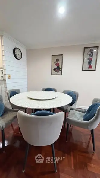 Charming dining area with modern round table and stylish chairs, perfect for cozy family gatherings.