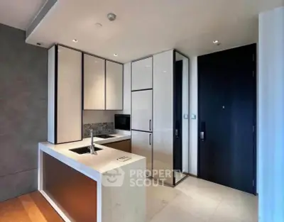 Modern kitchen with sleek cabinetry and integrated appliances in a luxury apartment.