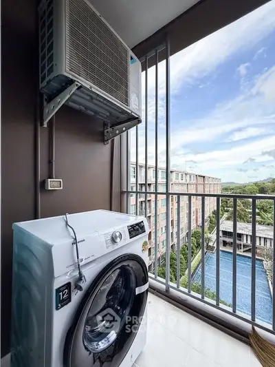 Modern balcony with washing machine and scenic view of pool and greenery, perfect for urban living.