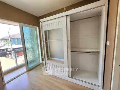 Spacious bedroom with large wardrobe and balcony access in modern home