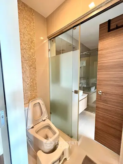 Modern bathroom with sliding glass shower door and stylish fixtures