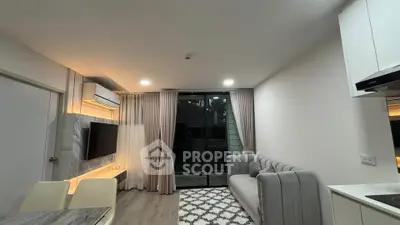 Modern living room with elegant decor and large sliding glass doors leading to a balcony.
