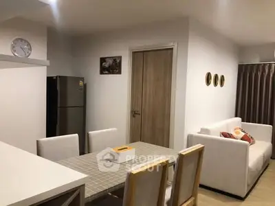 Modern dining area with stylish furniture and neutral decor in a cozy apartment setting.