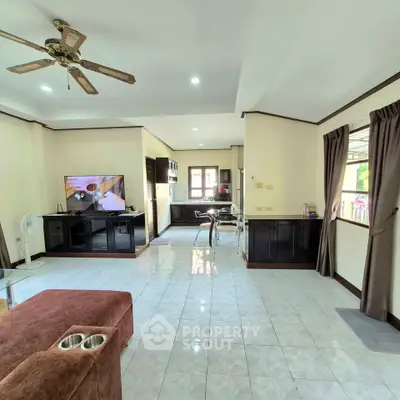 Spacious living room with open layout and modern kitchen