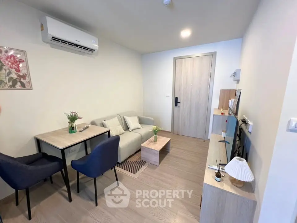 Modern living room with cozy seating and stylish decor in a contemporary apartment.