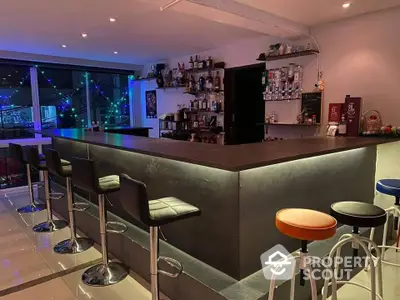 Stylish modern home bar with sleek counter and ambient lighting