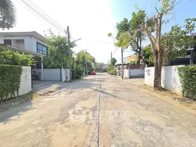 Charming residential street with modern houses and lush greenery, perfect for serene living.