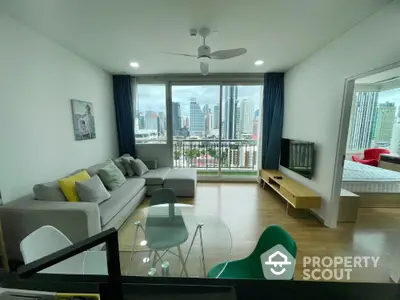 Modern living room with city view, stylish furniture, and large windows for natural light.